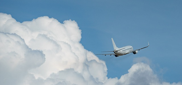 airplane flying with clouds